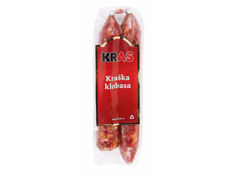 Dve vakuumsko pakirani suhi klobasi z rdečo etiketo z napisom 'Kraška klobasa'.