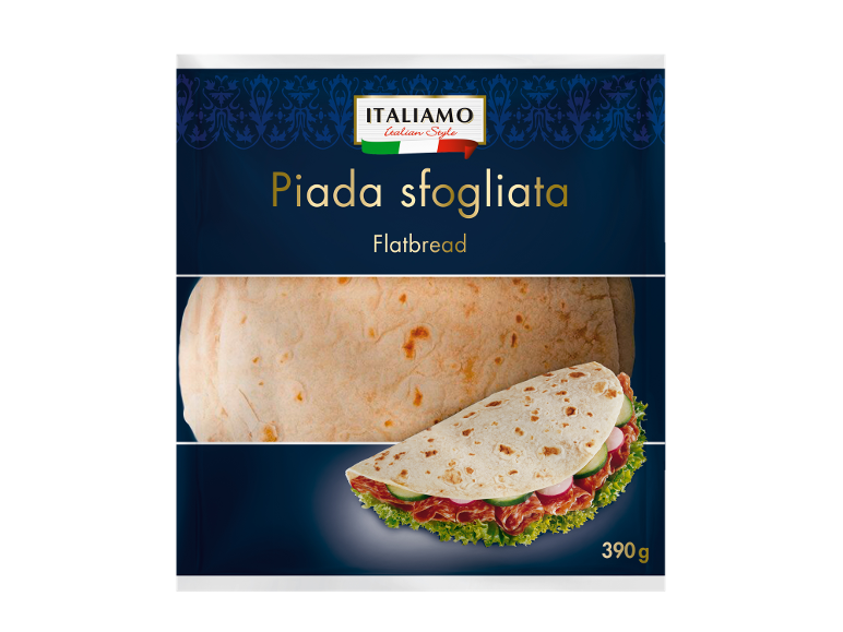 Ploščat kruh z mesom, kumarami in solato, v ozadju ploščat kruh. Teža: 390 g.