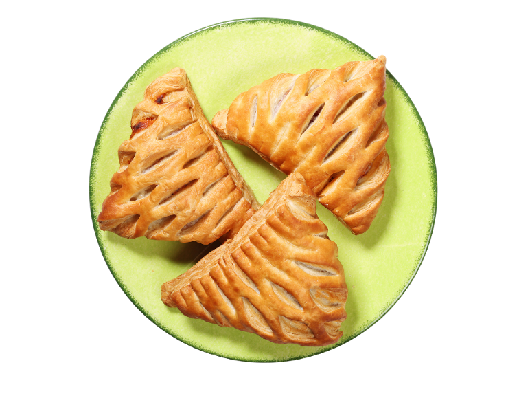 Tri listnata peciva z nadevom, postrežena na limetno zelenem krožniku.