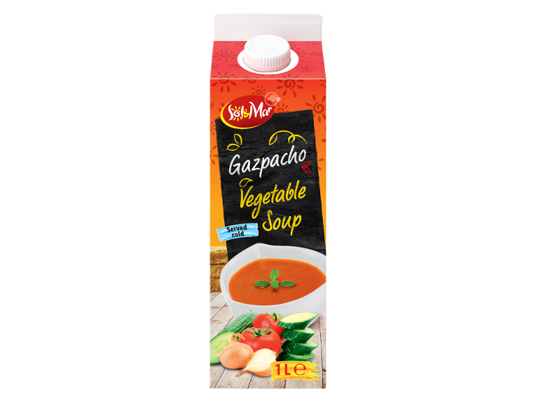 Karton zelenjavne gazpacho juhe, postrežene hladne, z skledo juhe in svežimi sestavinami.