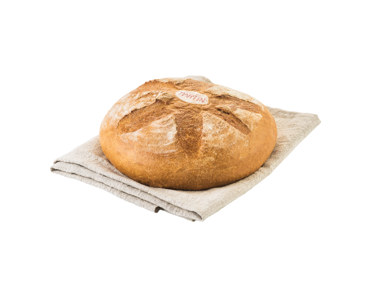 Okrogel hlebec kruha s hrustljavo skorjo na platneni krpi.