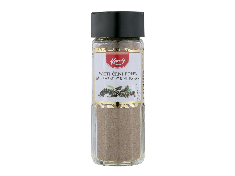 Steklen kozarec mletega črnega popra z belo in zlato etiketo.