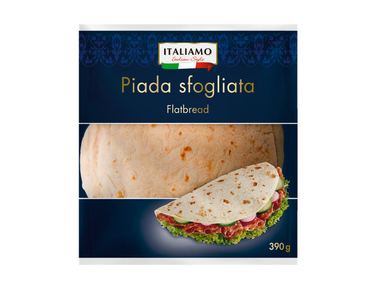 Ploščat kruh z mesom, kumarami in solato, v ozadju ploščat kruh. Teža: 390 g.