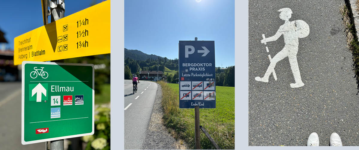 Oznake za kolesarske in pohodniške poti v Ellmauju, Tirolska, z informacijami o parkirišču pri zdravniški ordinaciji.