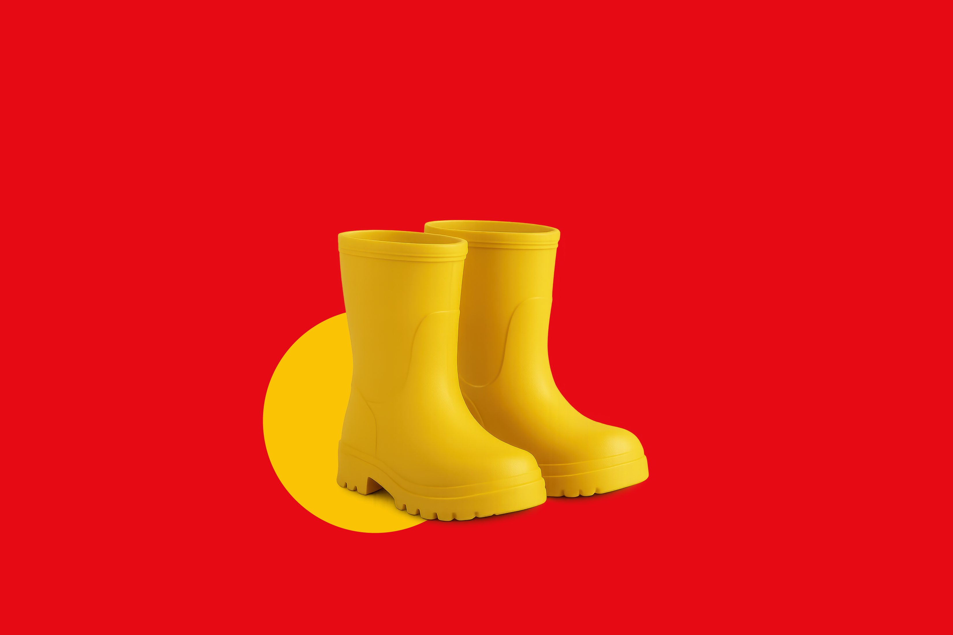 Par rumenih gumijastih škornjev na rdečem ozadju z rumenim krogom.