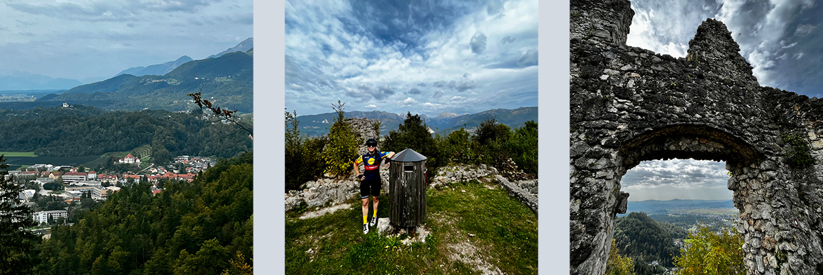 Kolesarka pri ruševinah, panoramski pogled na mesto in gore.