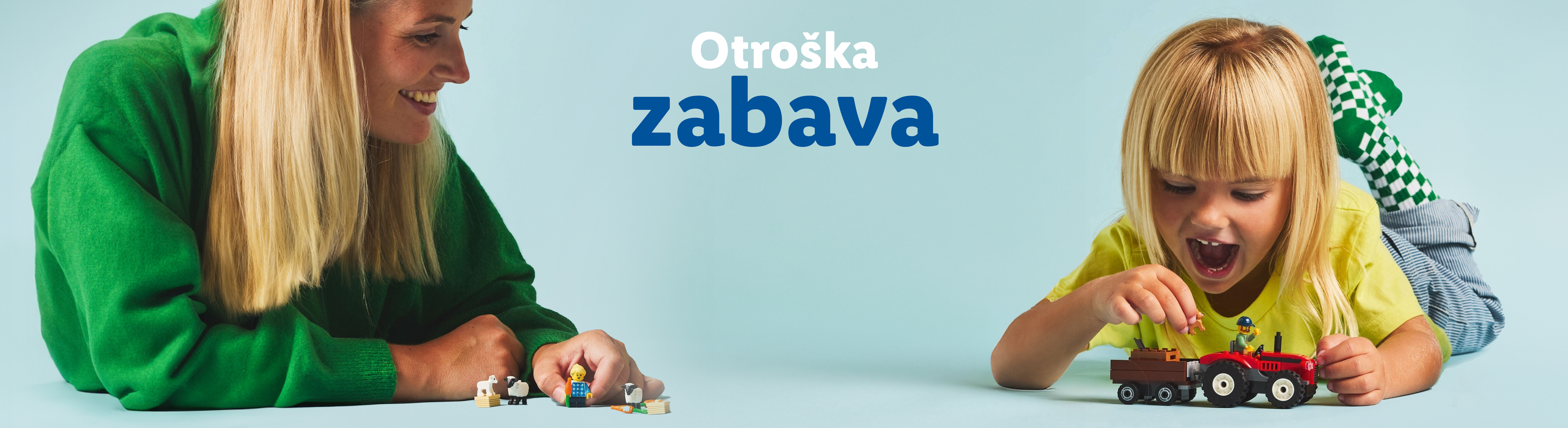 Mama in otrok se igrata z LEGO kmetijskimi igračkami.