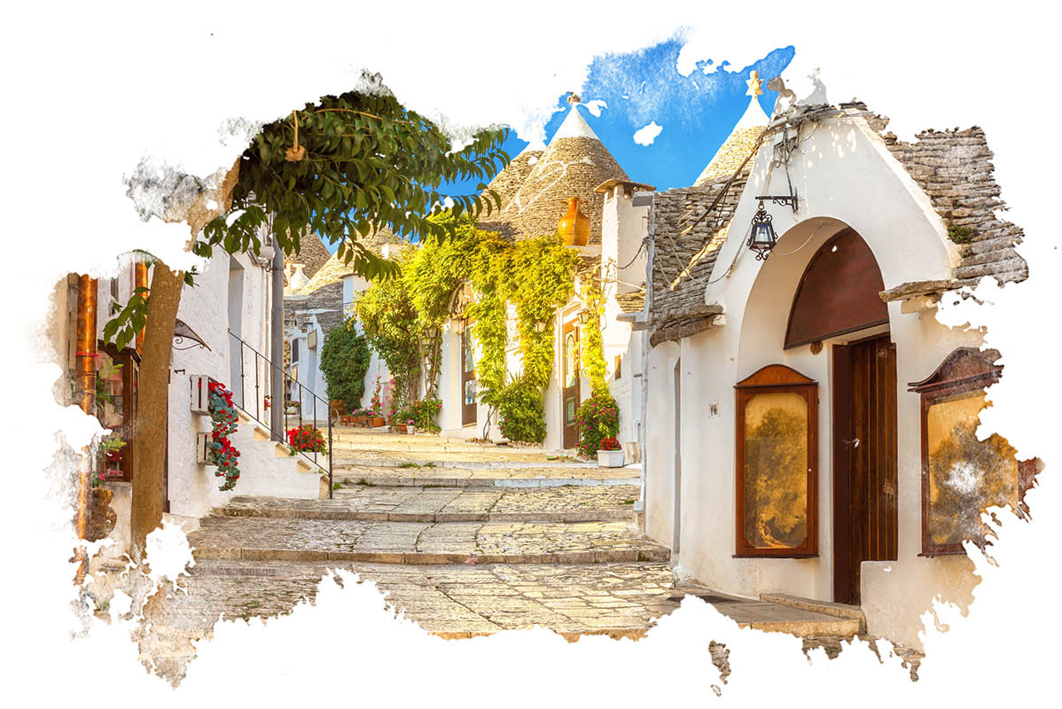 Trulli hiše, bele hiše in tlakovana ulica v Italiji.
